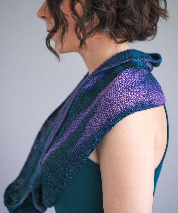 image of knit cowl around a woman's neck standing in a profile view