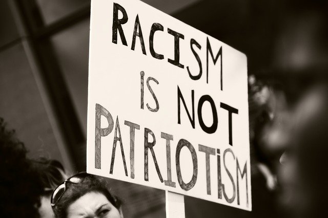 black and white racism is not patriotism sign