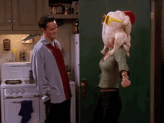 Monica from friends wearing a turkey on her head and dancing